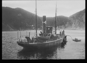 Image of Vessel stern. Dory with two men near